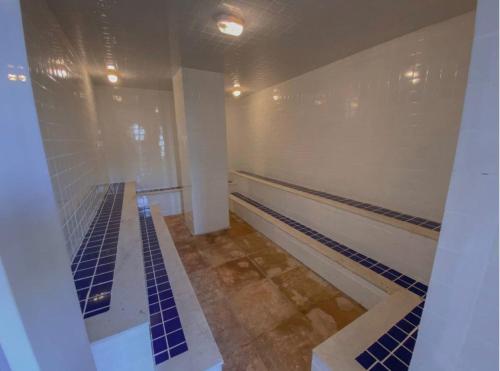 a bowling alley with blue tiles on the floor at Arraial d Ajuda - Casa Oásis - Residencial Monte das Oliveiras in Porto Seguro