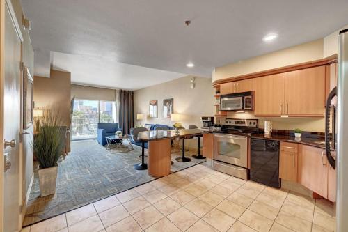 a kitchen with a table and a dining room at Royal Oasis Suite at Platinum Hotel-Strip Views in Las Vegas