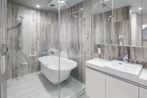 a bathroom with a sink and a toilet and a shower at LEGA LAND Sangenjaya ANNEX in Tokyo