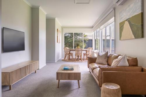 a living room with a couch and a table at Red Rocks Golf & Accommodation - Phillip Island in Cowes