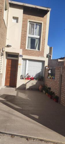 a house with a large window and a driveway at Andrés Arro in Viedma
