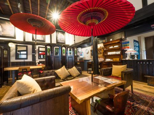 a room with two red umbrellas hanging from the ceiling at Yufuin Lamp no Yado in Yufuin