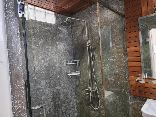 a shower with a glass door in a bathroom at CHILCHILL Elite Residences BKK2 in Phnom Penh
