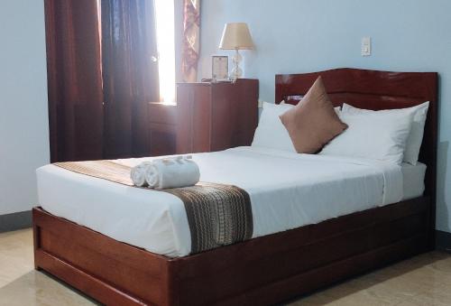 a bedroom with a large bed with a stuffed animal on it at RedDoorz @ ARRS HOTEL & RESORT in Tagum