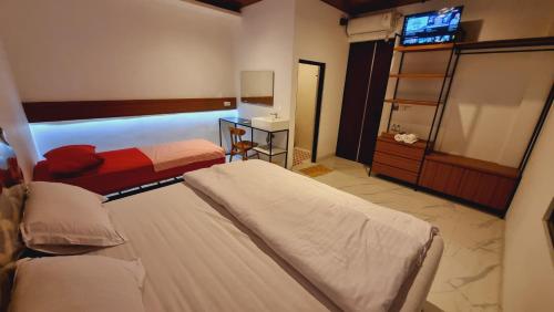 a hotel room with two beds and a mirror at Batik Inn Semarang in Semarang
