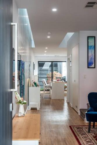 a living room with chairs and a dining room at Kashida - Persian-Style Townhouse with Office in Marion