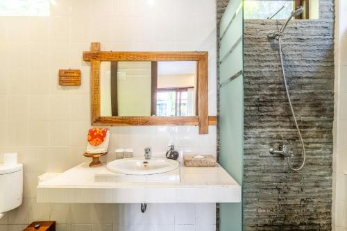 a bathroom with a sink and a mirror at Meruhdani Boutique Hotel Ubud in Ubud