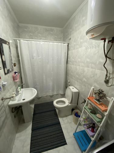 a bathroom with a white toilet and a sink at Azur 5 Stars Cozy room in Cairo