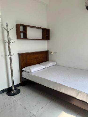 a bedroom with two beds and a mirror on the wall at Blue Ocean in Dehiwala
