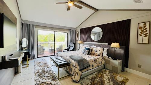 a bedroom with a bed and a mirror at LuxeTPC Sawgrass - Immaculate Villa at the TPC in Ponte Vedra Beach