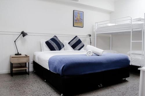 a bedroom with a large bed and a bunk bed at The Village Cairns in Cairns