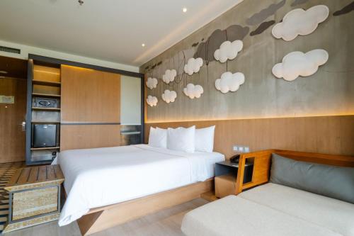 a hotel room with a bed and a couch at ARTOTEL Sanur Bali in Sanur