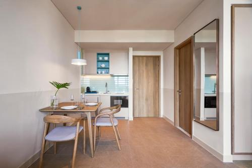 濠莊的住宿－IXORA Ho Tram By Fusion，厨房以及带桌椅的用餐室。