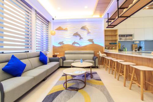 a living room with a couch and tables and a kitchen at Whale Yan Homestay in Toucheng