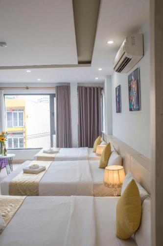 a hotel room with two beds and a television at Lis Hotel in Danang