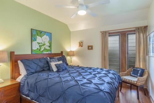 a bedroom with a blue bed and a ceiling fan at Kaha Lani 304 in Lihue