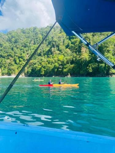 two people in a kayak in the water on a boat at La Purruja Lodge in Golfito