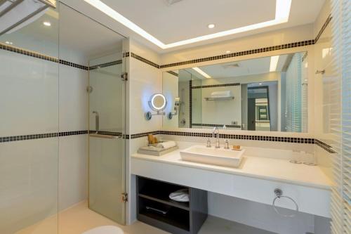 a bathroom with a sink and a shower at The Boathouse Phuket-SHA Plus in Kata Beach