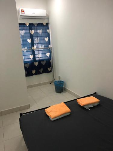 a room with a bed with two towels on it at 5 stars Rawang homestay in Rawang