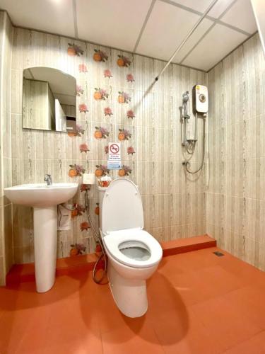 a bathroom with a toilet and a sink at Chinda Boutique Hotel in Chiang Mai