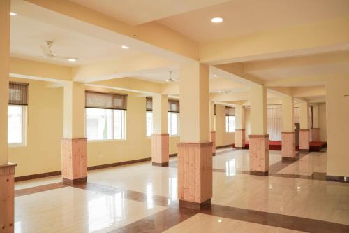 an empty room with pillars in a building at Hotel Maenamla Namchi - yagi group in Namchi