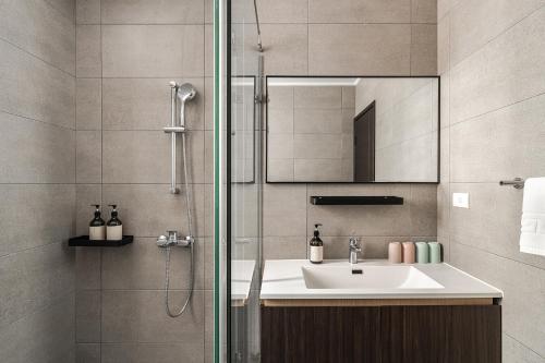 ein Badezimmer mit Waschbecken und Dusche in der Unterkunft Antler Guest House in Magong