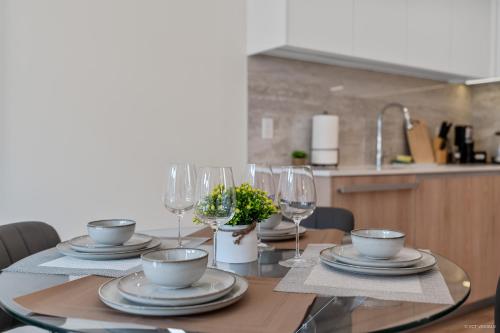 a dining room table with glasses and plates on it at Stylish and Tranquil Retreat in Richmond City Center in Richmond