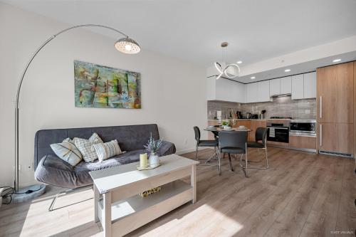 a living room with a couch and a table at Stylish and Tranquil Retreat in Richmond City Center in Richmond