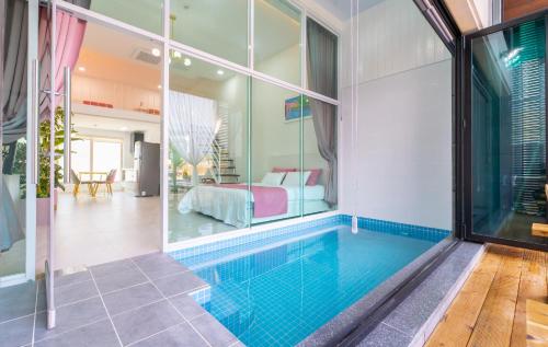 a swimming pool in a house with a bedroom at Patio Pool Villa in Gyeongju