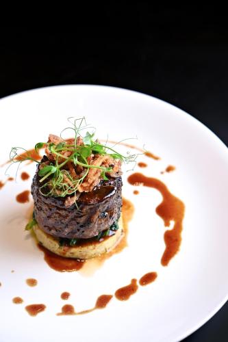 a white plate with a piece of food on it at Shangri-La Jakarta in Jakarta