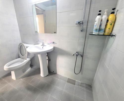 a bathroom with a toilet and a sink and a shower at Wandonesia in Wando