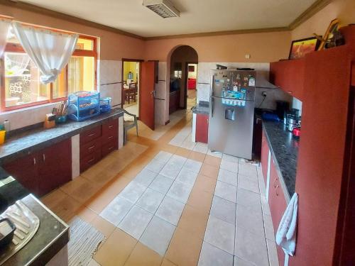 a kitchen with a refrigerator and a counter top at tulia liqizo homestay in Mombasa