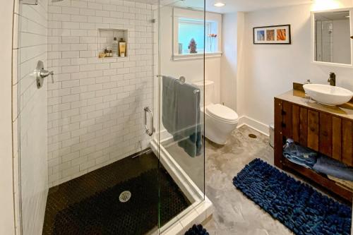 a bathroom with a shower and a toilet and a sink at West Woodland Wonder in Seattle