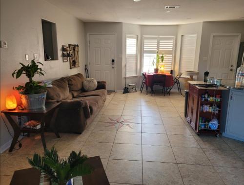a living room with a couch and a table at Bedroom Four minutes from beach in Pensacola