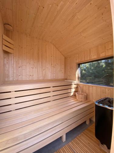 a wooden sauna with a large window at Duża Holenderka - Lewy Brzeg Narwi in Burlaki