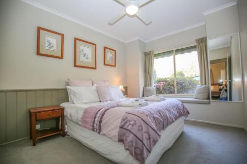 a bedroom with a large bed and a window at Silver Birches Holiday Village - Unit 6 in Bright
