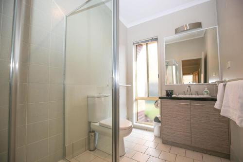 a bathroom with a shower and a toilet and a sink at Silver Birches Holiday Village - Unit 6 in Bright