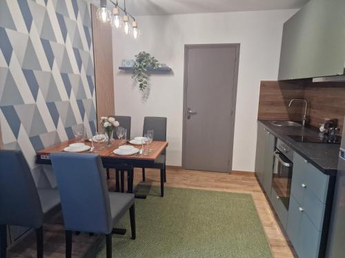 a kitchen with a table with chairs and a dining room at Maison d'hôtes avec 3 appartements et un studio in Viry-Châtillon