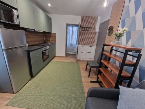 a small kitchen with a couch and a kitchen rug at Maison d'hôtes avec 3 appartements et un studio in Viry-Châtillon