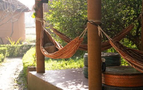 a hammock hanging from a pole in a yard at Sunsetview Bardia in Bardia