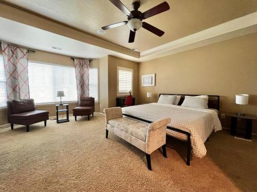 a large bedroom with a bed and a ceiling fan at Large 5BR Retreat - Hot Tub - Gym - Games - I-25 in Castle Rock
