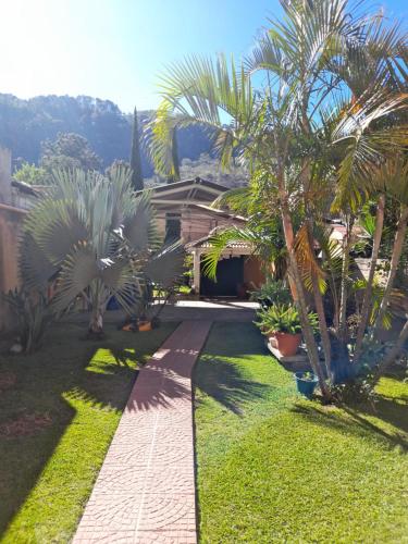 a garden with palm trees and a house at Casa de Alondras in Panajachel