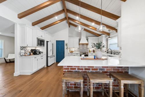 a kitchen with white cabinets and wooden ceilings at *New* Casa Azul-4B4B Upscale Oasis-Pool in San Antonio