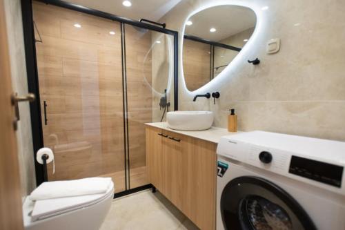 a bathroom with a sink and a washing machine at Sweet memories in amazing Villa Eualia w pool in Anópolis