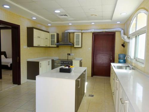 a kitchen with a white counter top in a room at Villa Room #6 in Umm Al Sheif in Dubai
