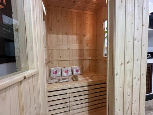 a sauna with wooden paneled walls and wooden floors at Cozy home @ Chatcuchak/中文服务 in Bang O