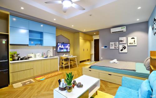 Il comprend une cuisine et un salon avec un lit et un canapé. dans l'établissement Harmony Vinhomes D'Capitale, à Hanoï