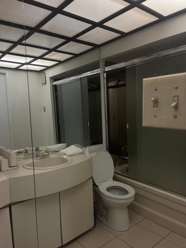 a bathroom with a toilet and a sink at Home in West Vancouver in West Vancouver