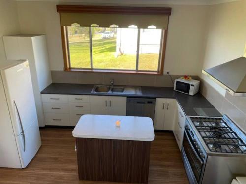 a kitchen with a stove and a counter top at Number 94 in Eden