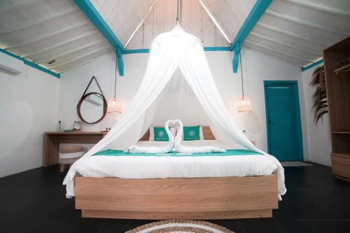 a bedroom with a bed with a canopy at Ubu Villa Prambanan - 3 Bedrooms Villa near Prambanan Temple in Prambanan